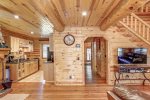 Eagle`s Lair main floor with wood wall coverings and log beams.